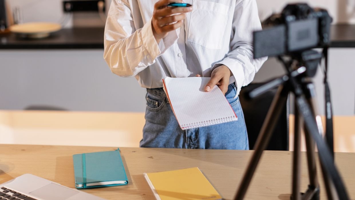 Someone watching a video and taking notes, the routine Evernote’s own guide describes.