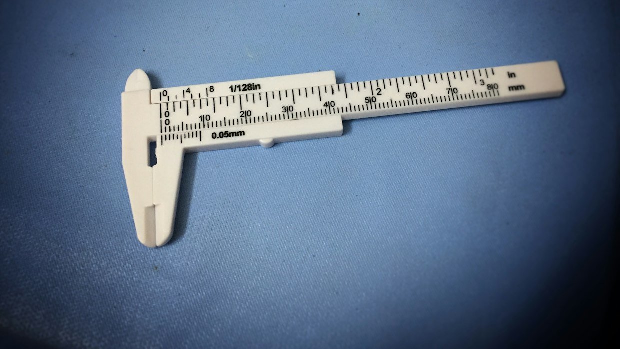 Calipers measuring a small object.