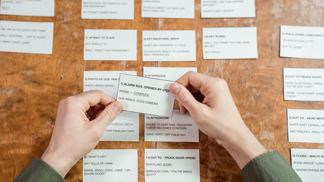 A hand writing on an index card.