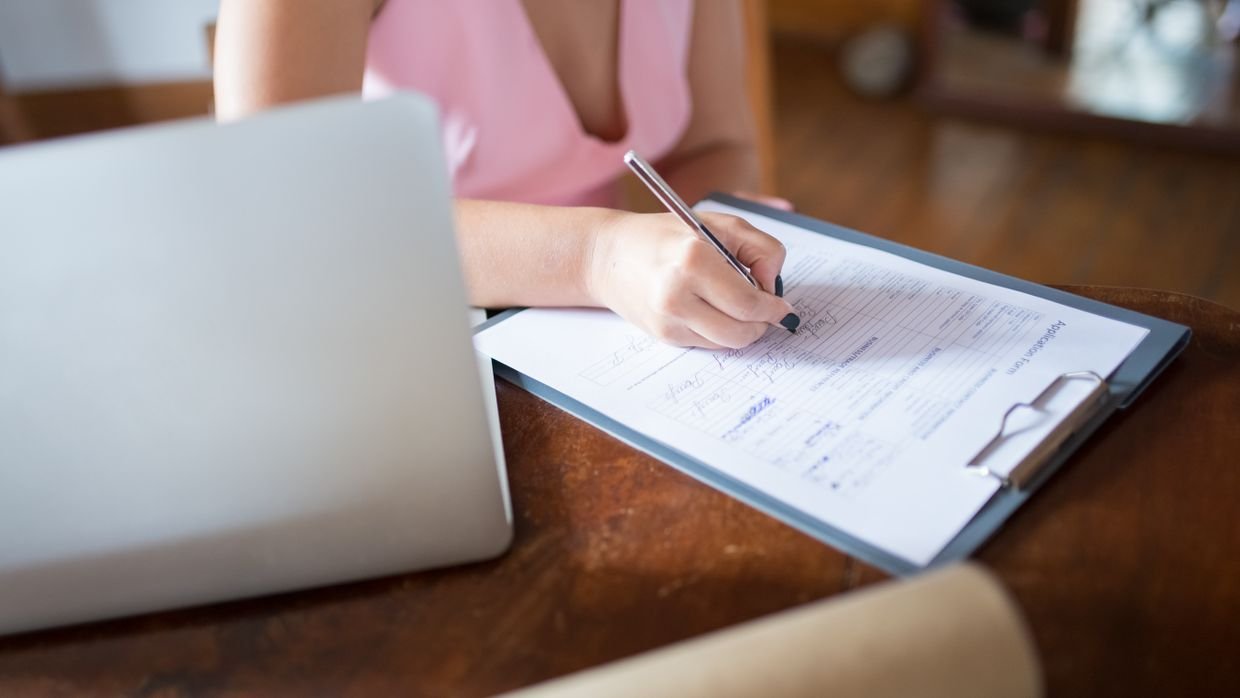Someone filling in a sign-up form on a laptop.