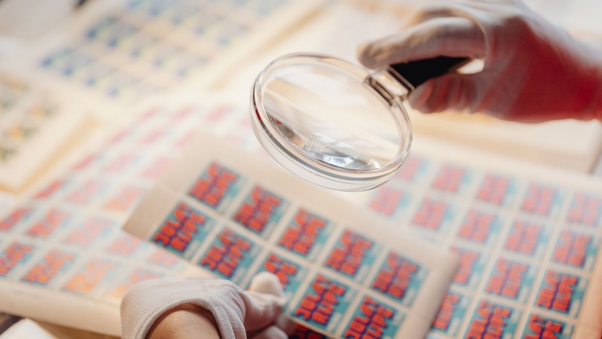 A magnifier held over small printed type.