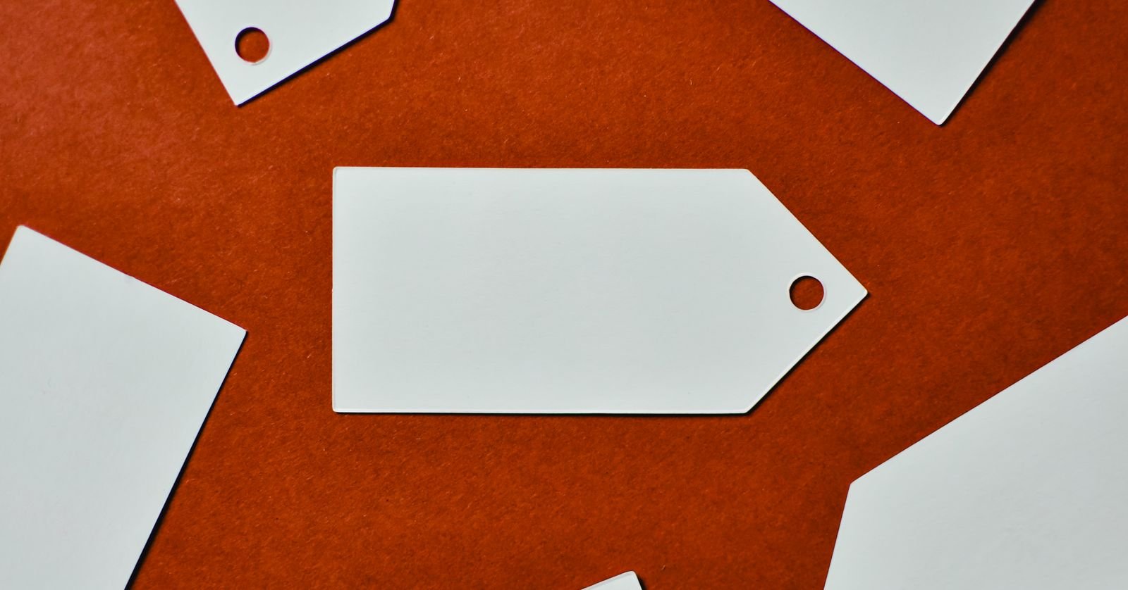 A blank price tag on a plain surface.