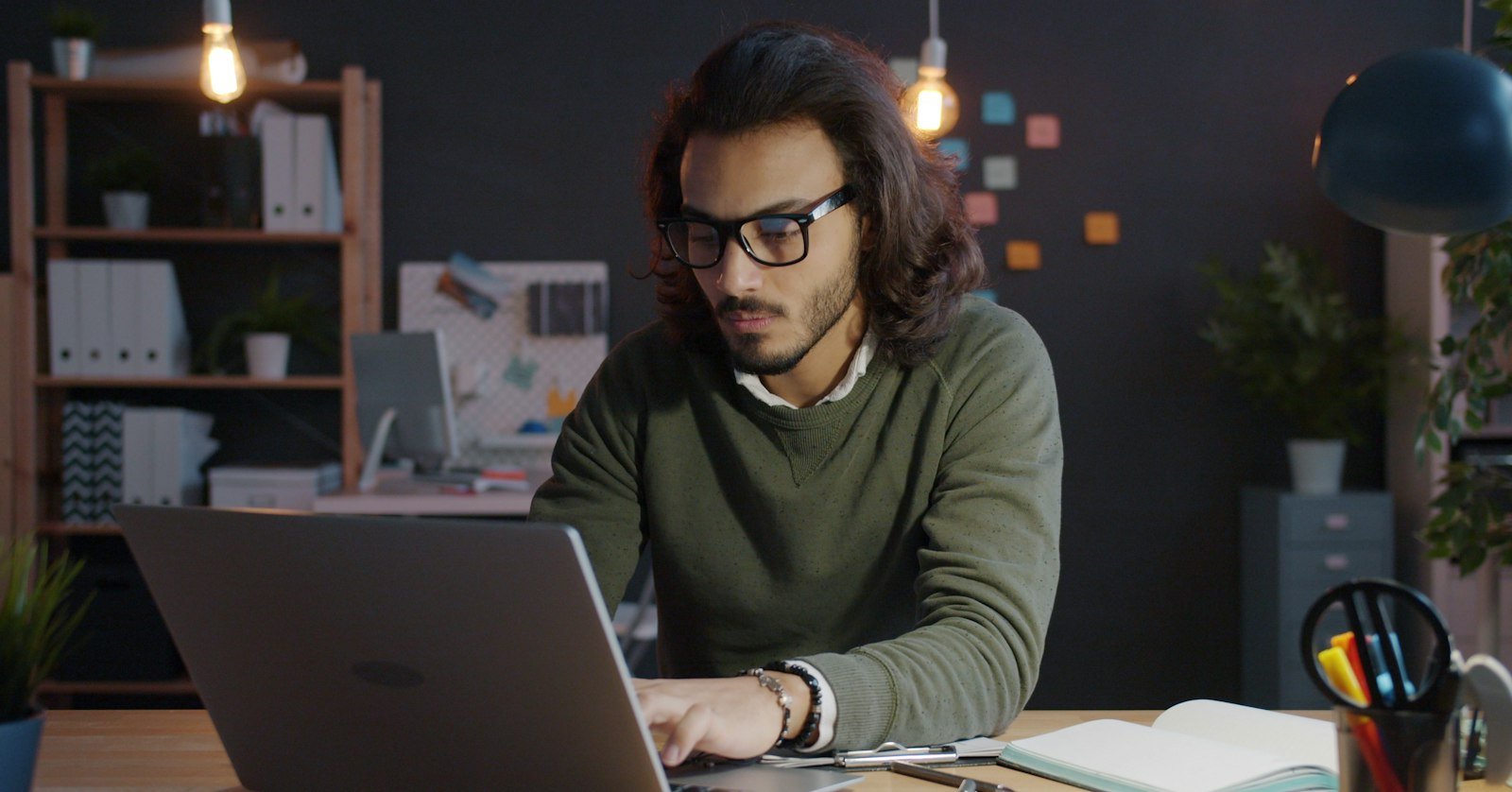A person typing a request on a laptop, as when asking Gemini to summarize a video.