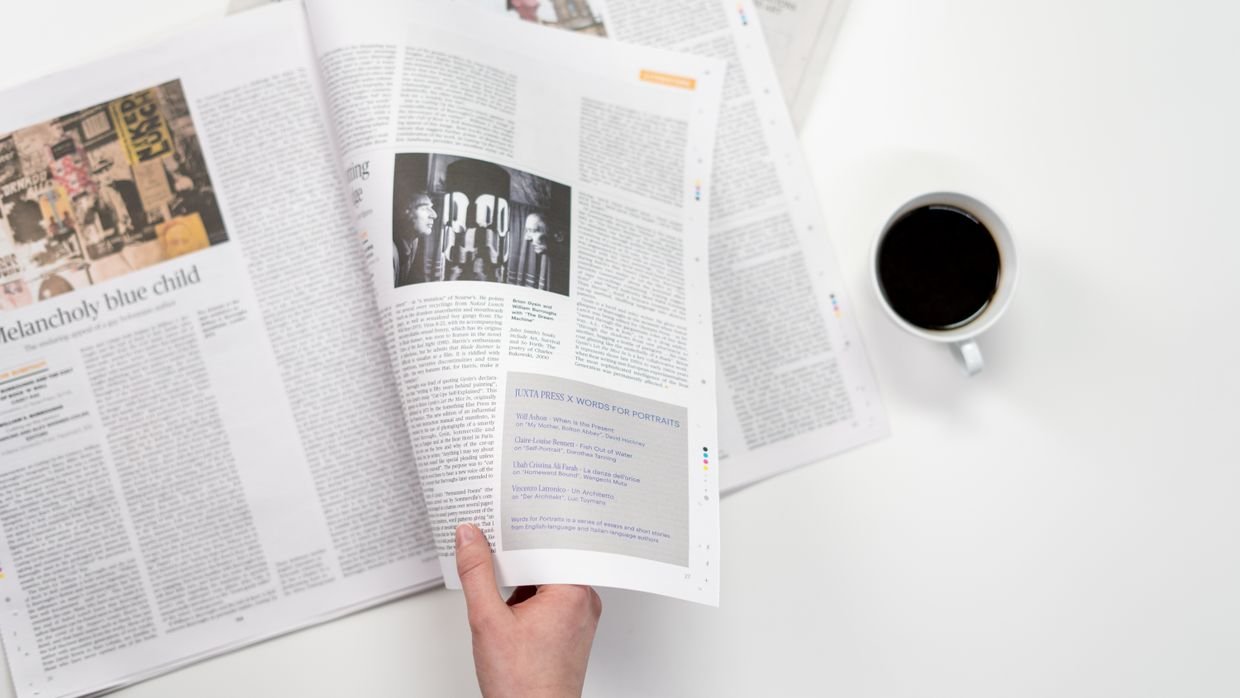 A handwritten page beside a printed article.
