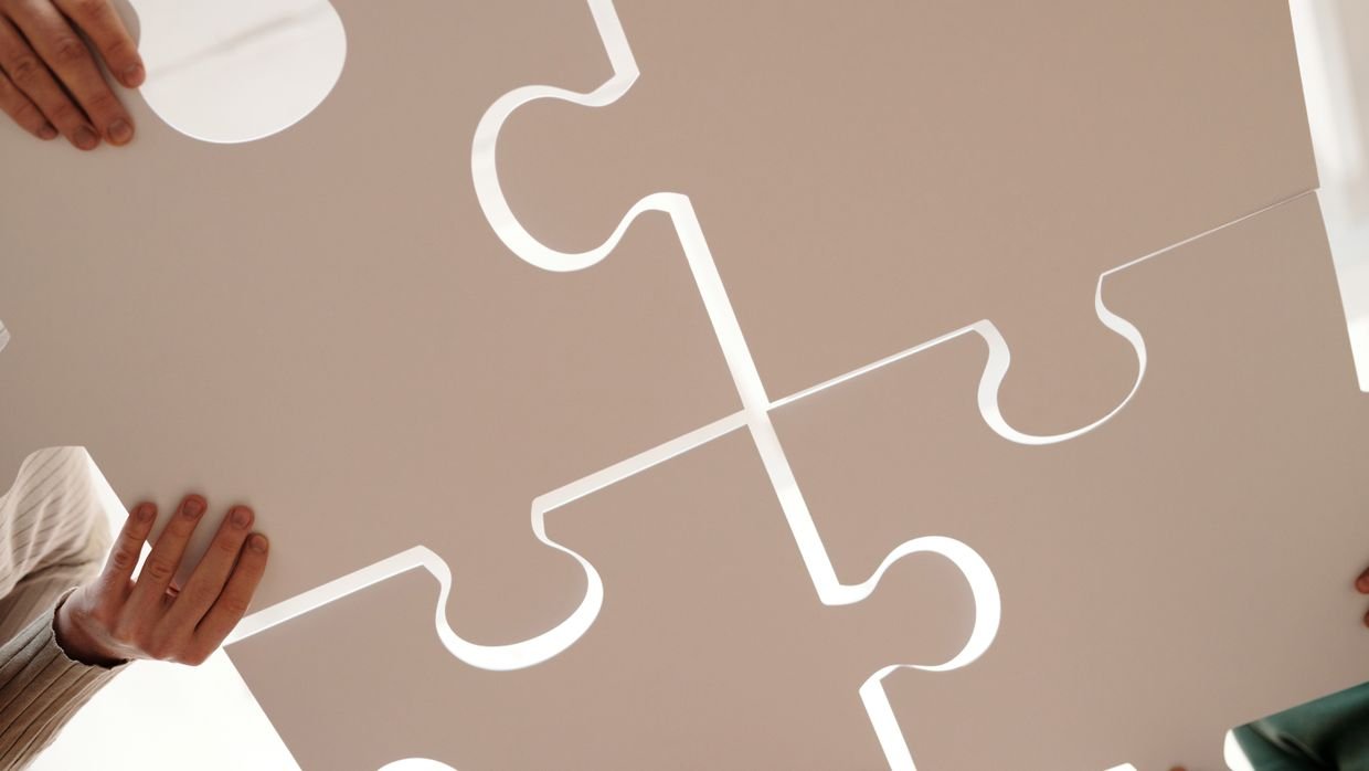 Two jigsaw pieces fitting together.