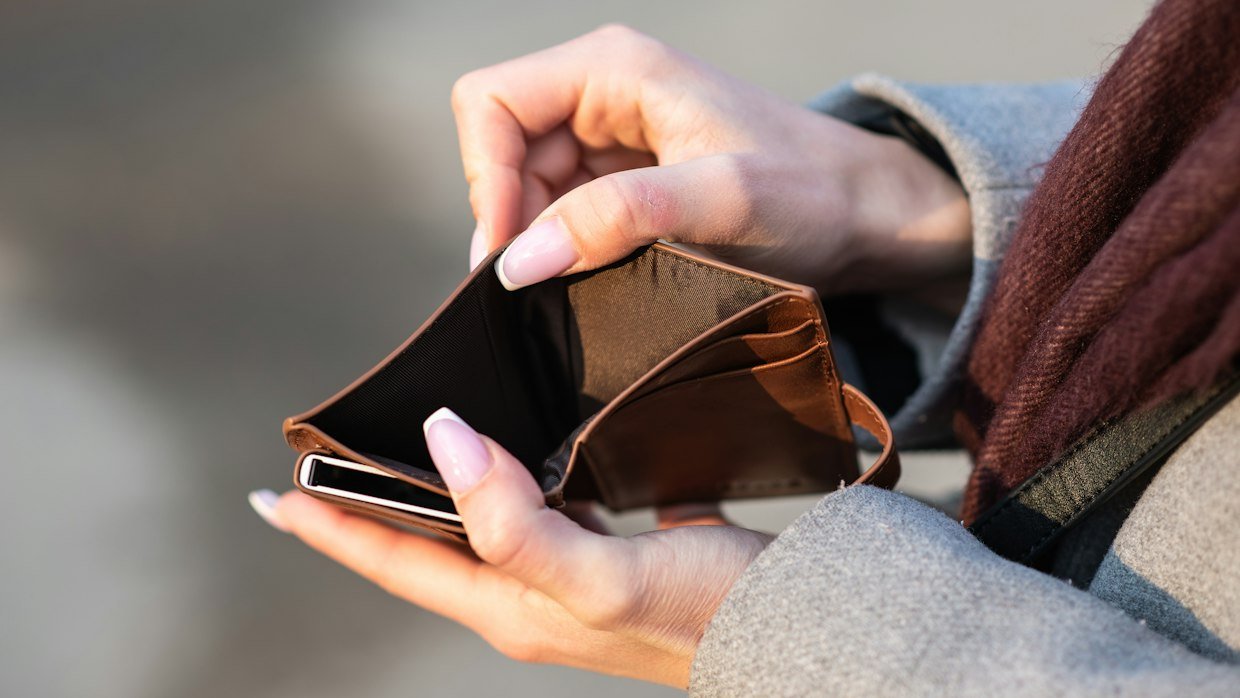An open, empty wallet on a table.