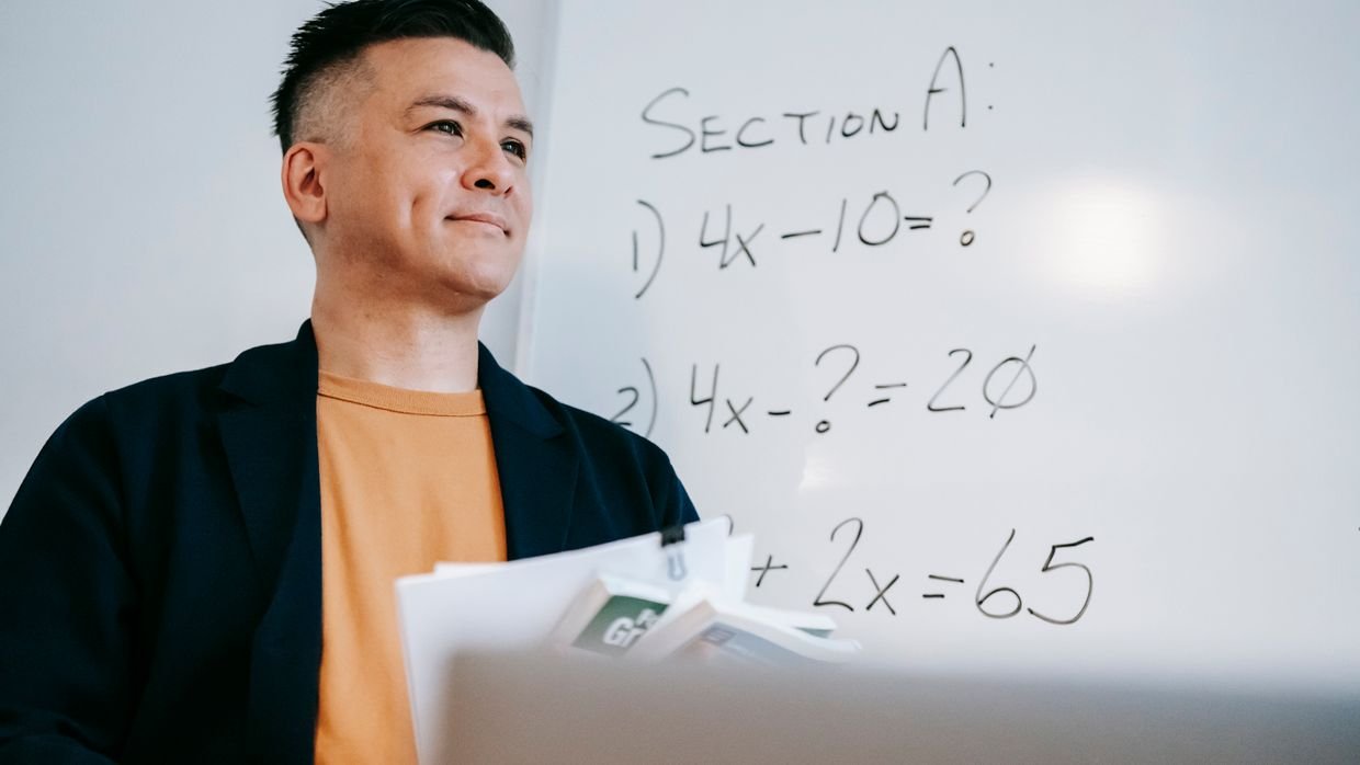Mathematical working written on a whiteboard.