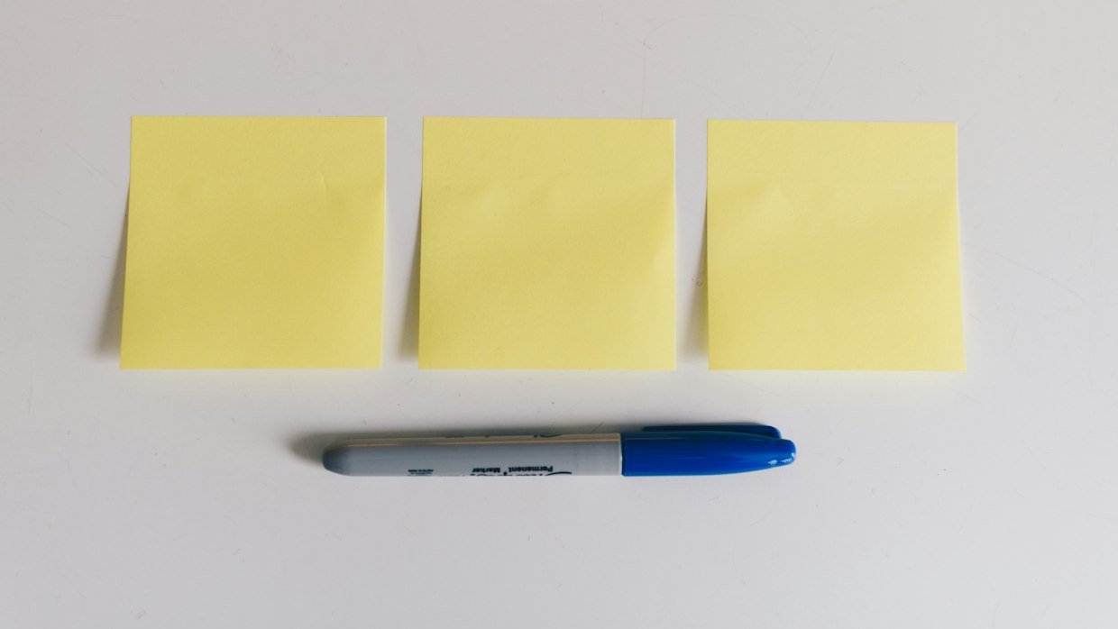 Highlighter pens lying beside handwritten notes.