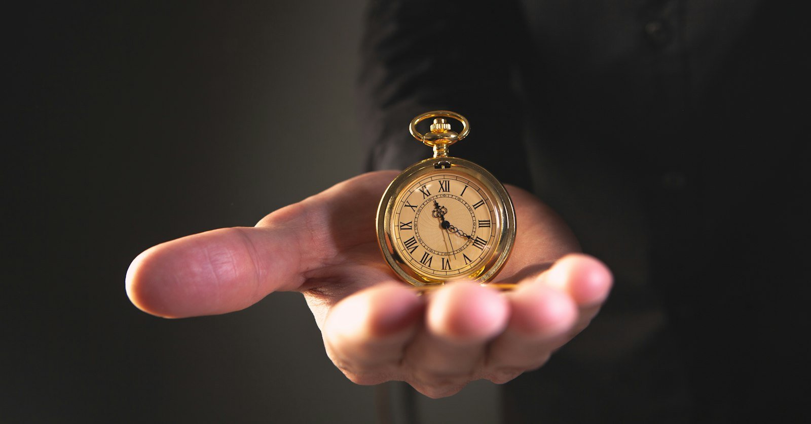 A stopwatch held in an open hand.