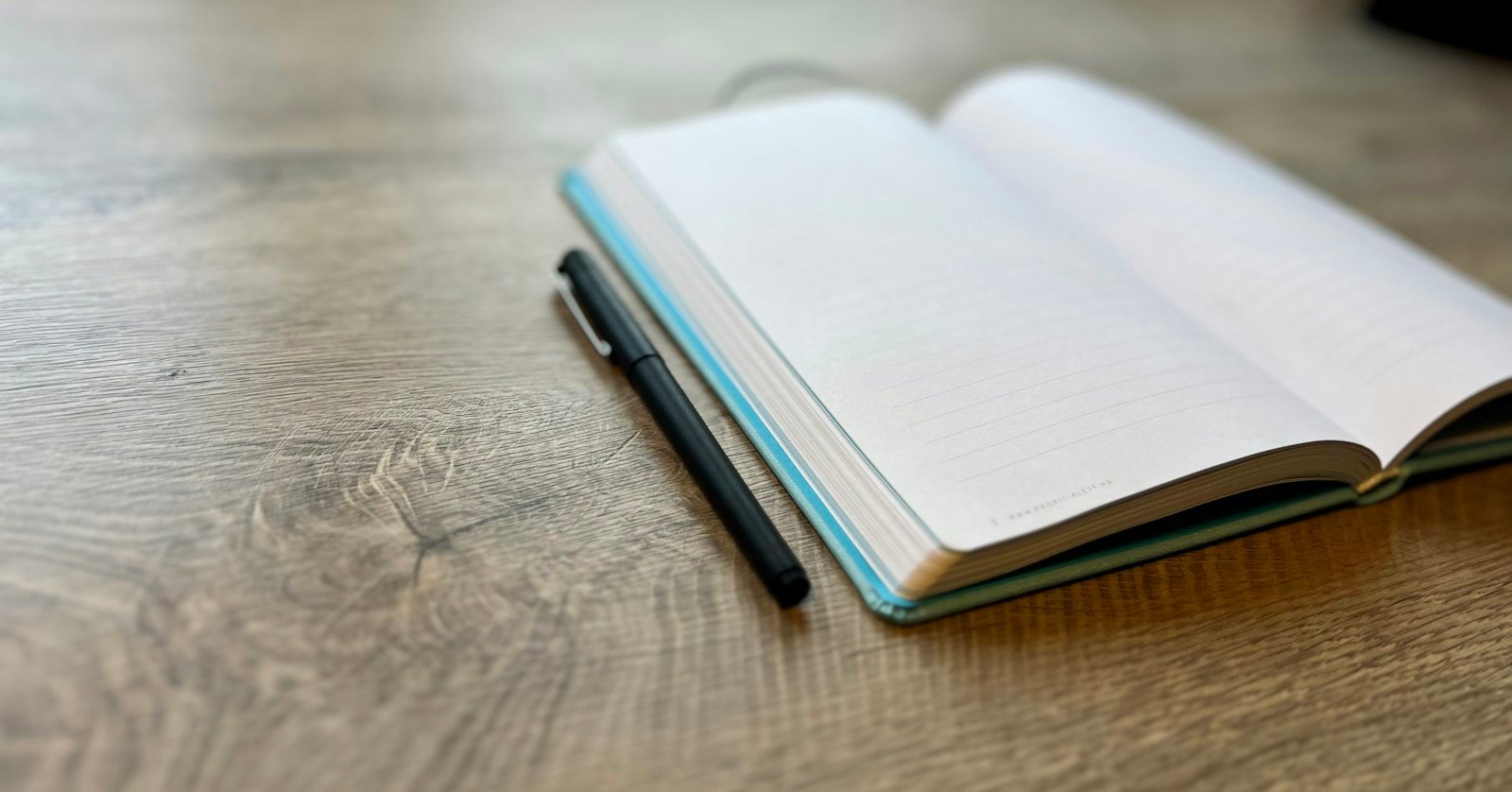 A reporter's notebook and pen on a desk.