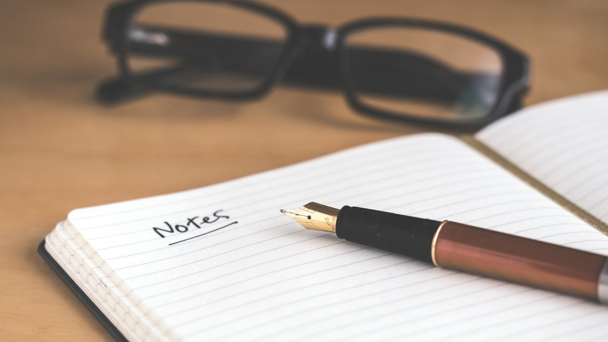 Handwritten notes filling a notebook page.