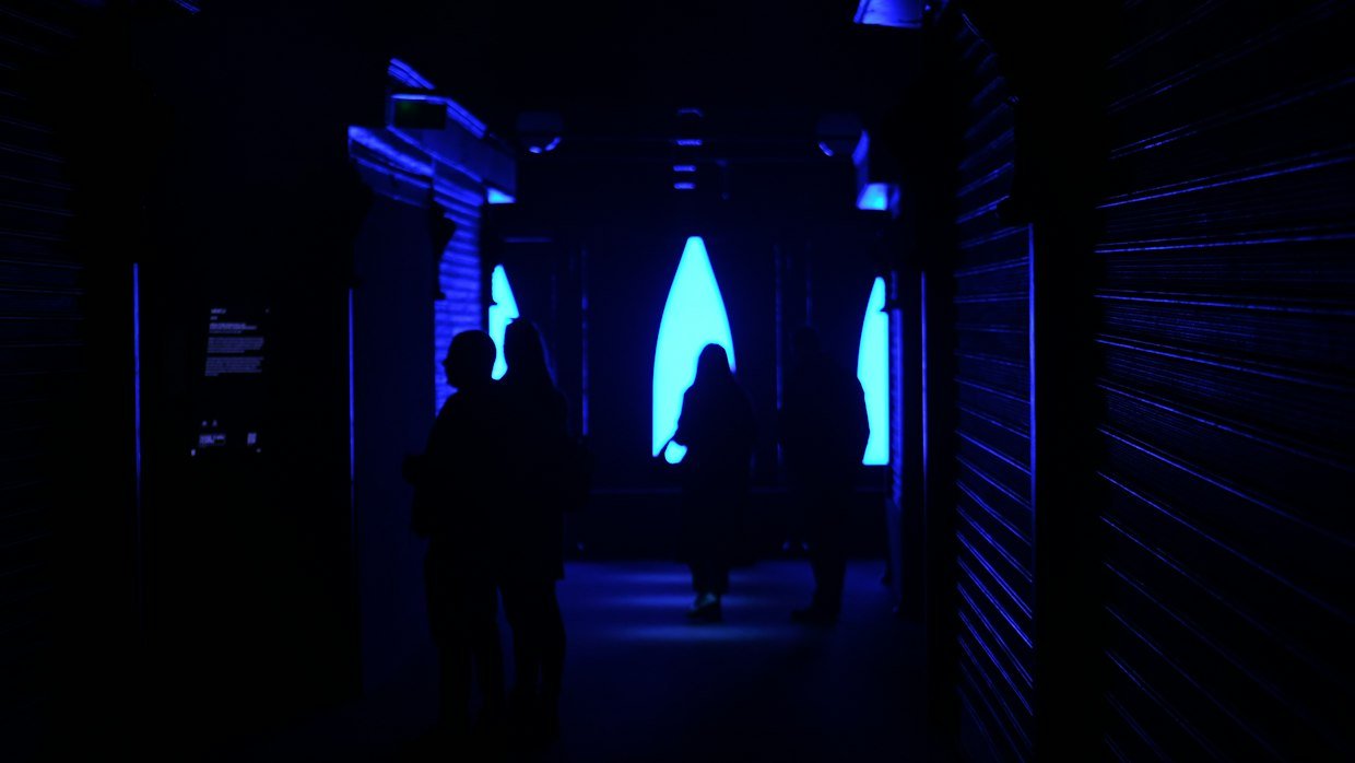 A large screen glowing in a darkened hall.