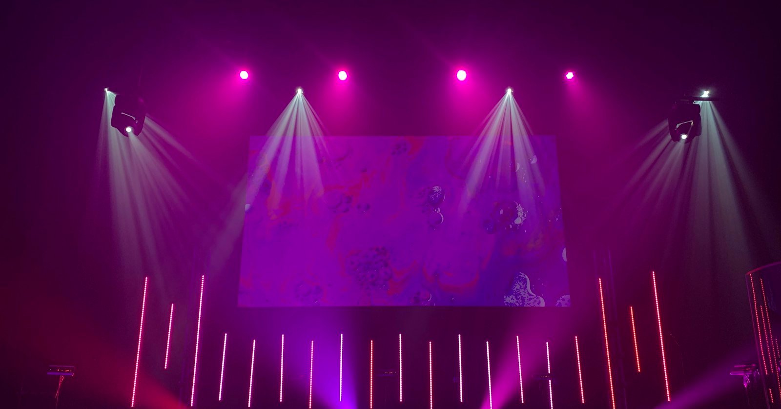 A brightly lit stage in front of an audience.