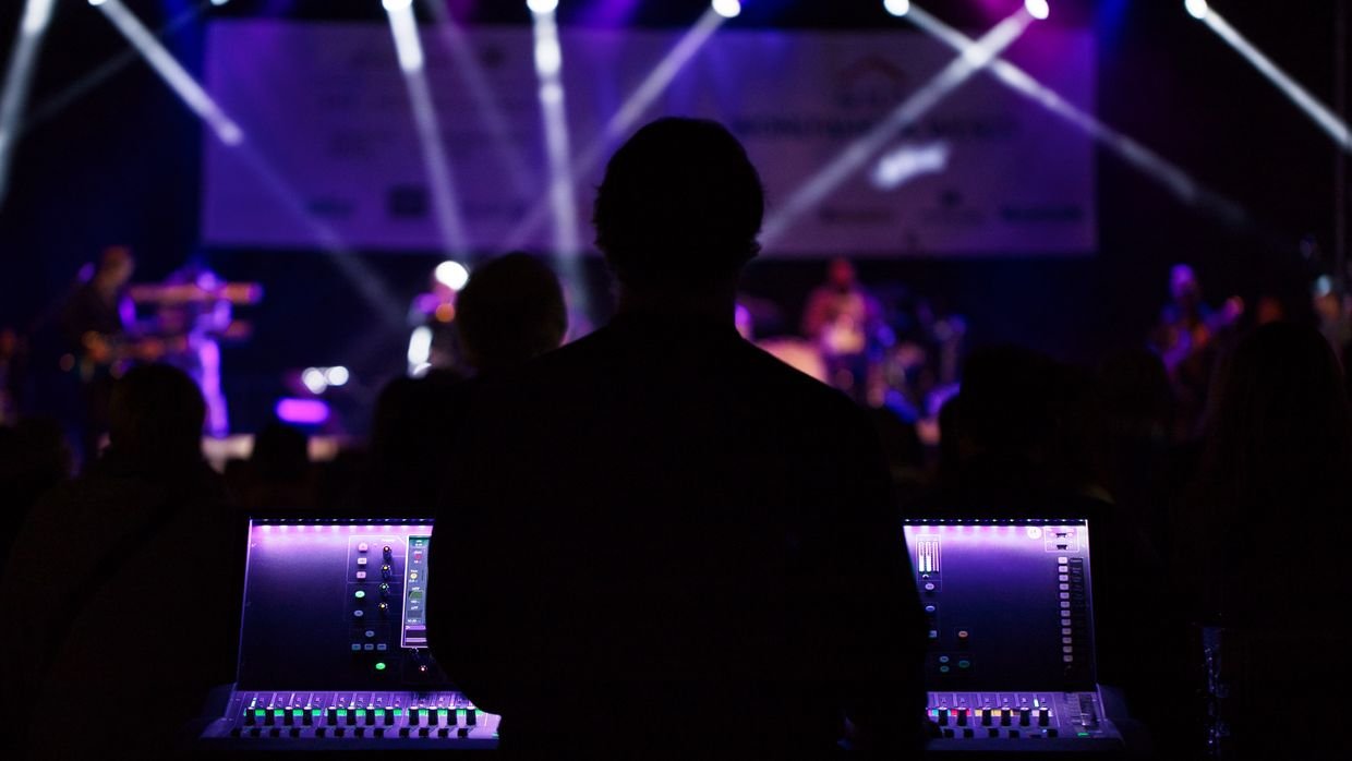 Stage lights switched off above an empty stage.