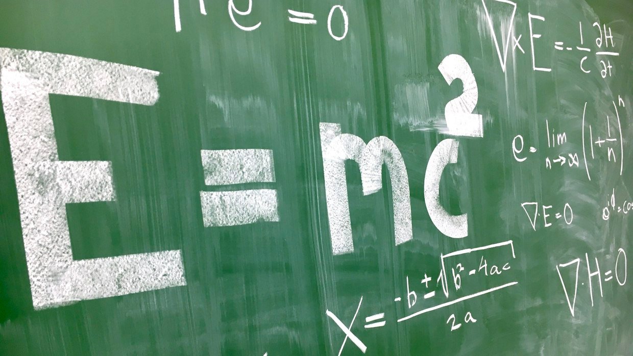 Equations written across a chalkboard.