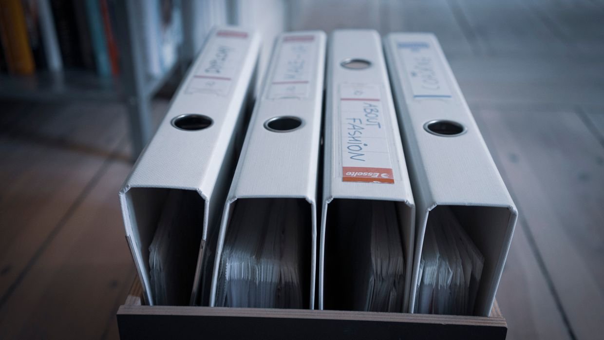 A ring binder with labelled dividers.