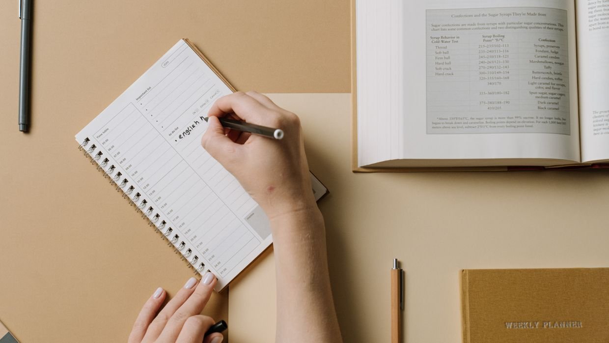 A weekly planner open on a desk.