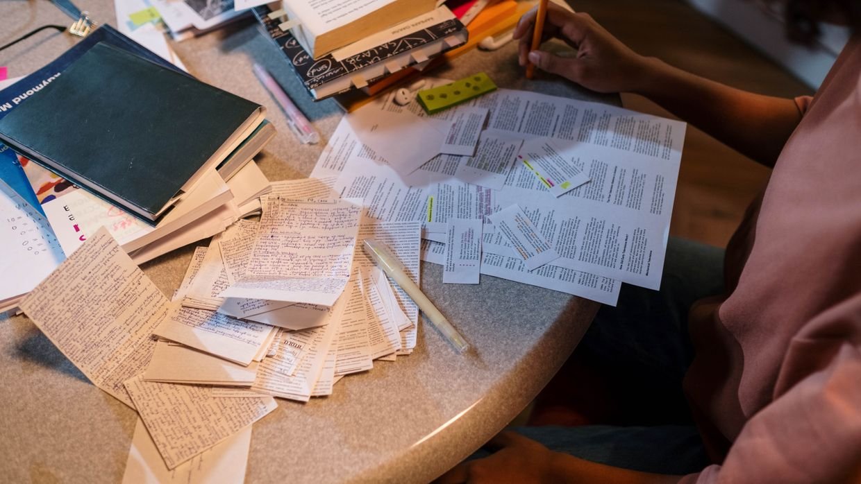 Revision notes spread across a student's desk.