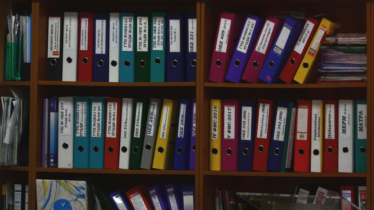 Rows of archive folders on a shelf.