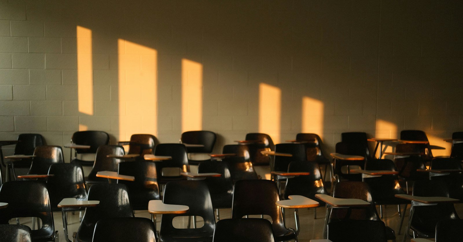 Empty seats in a university lecture hall.