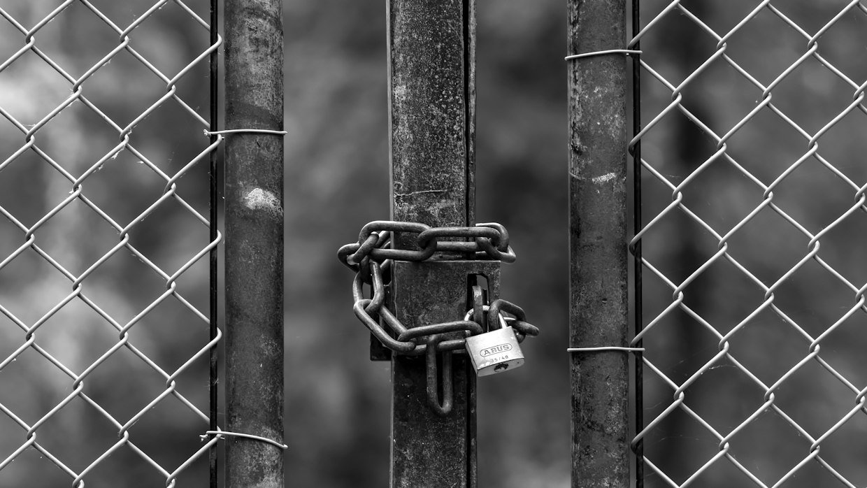 A locked gate blocking a path.