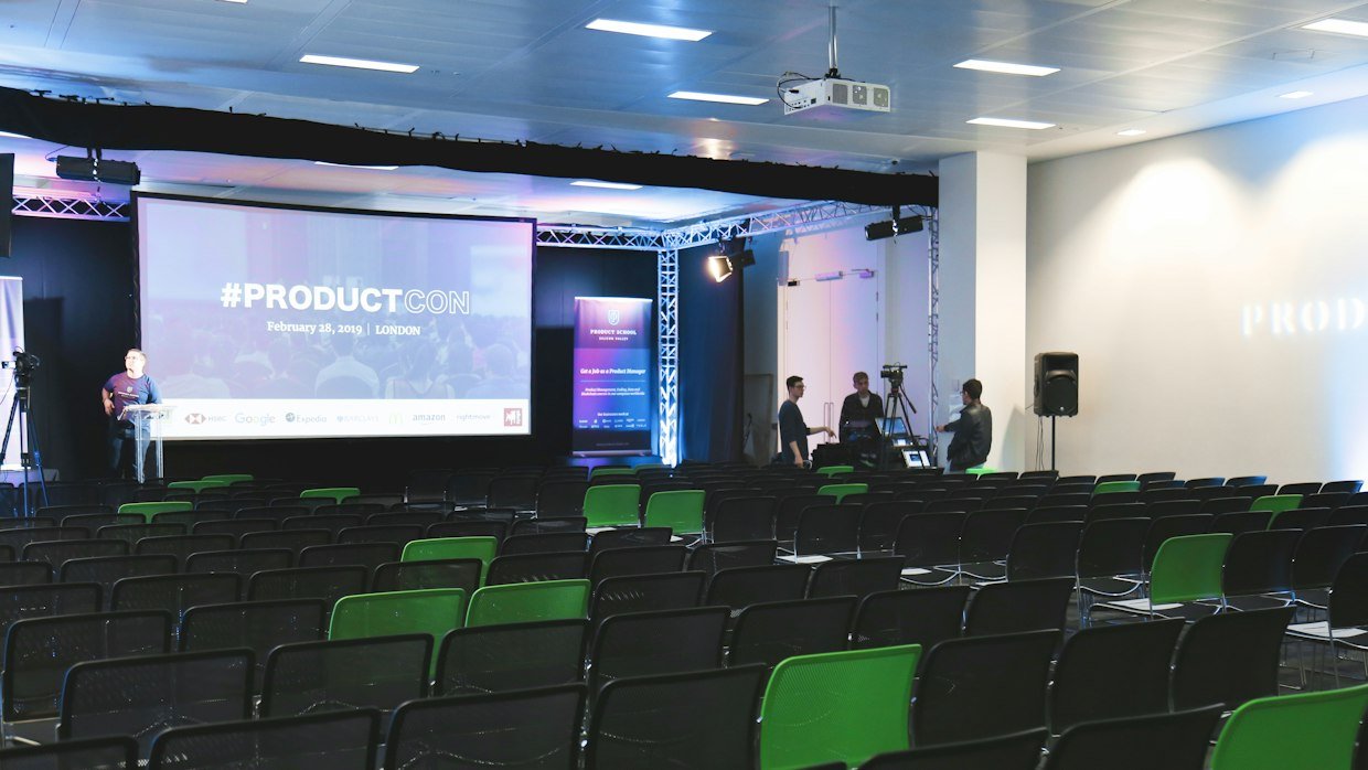 A conference stage with a large display screen.