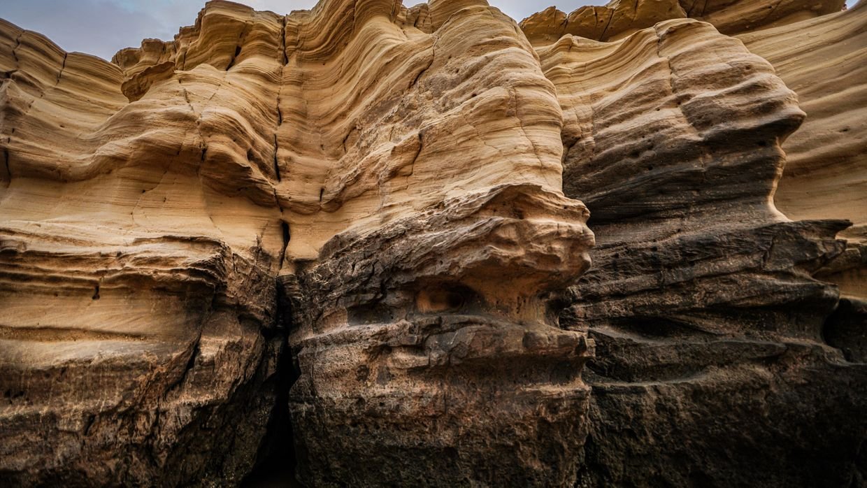 Layered bands of rock in a cliff face.