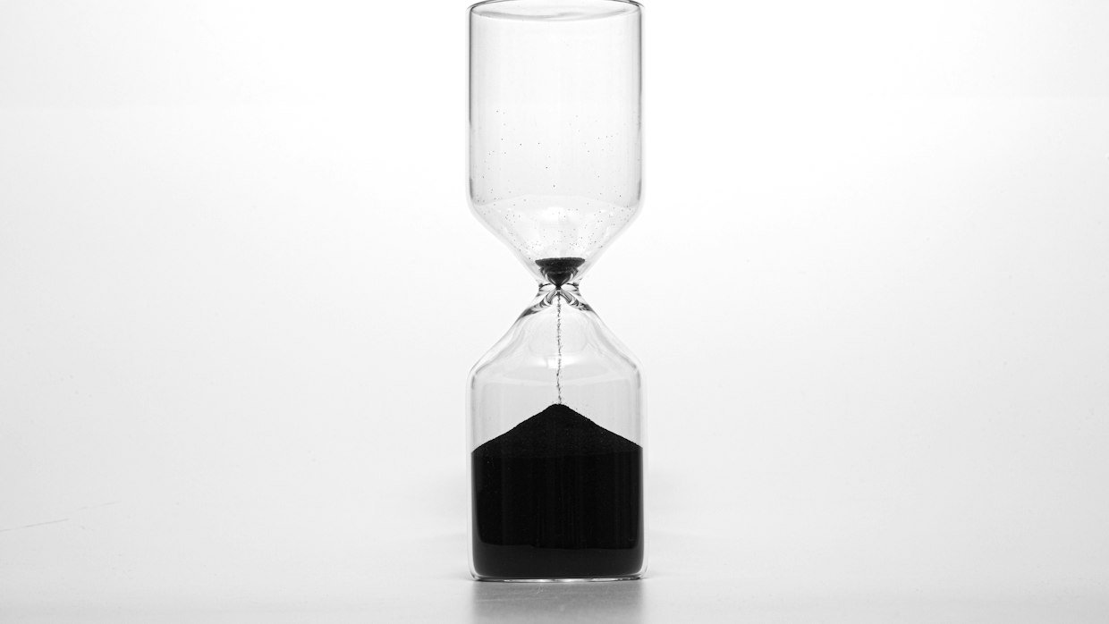 An hourglass with the sand part run through.