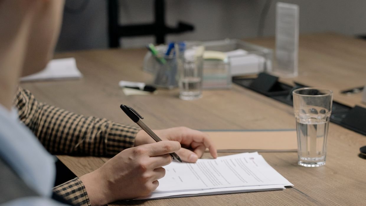 A document handed across a table.