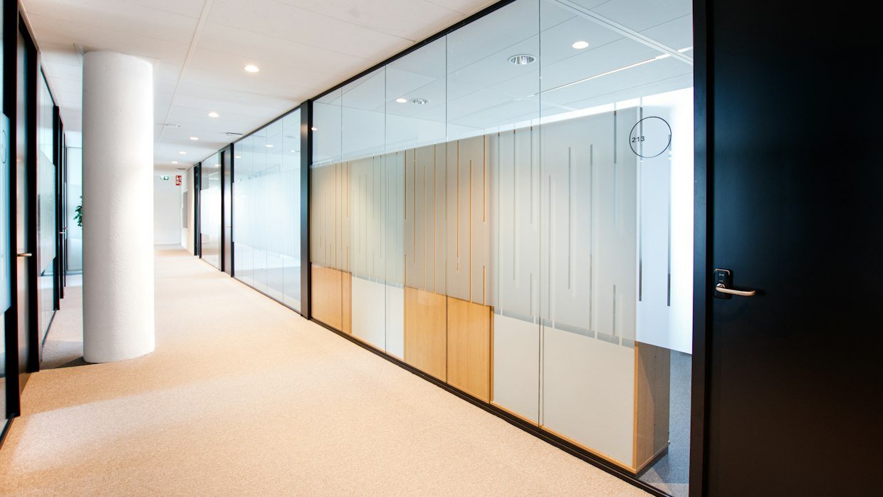 A wall clock in an office corridor.