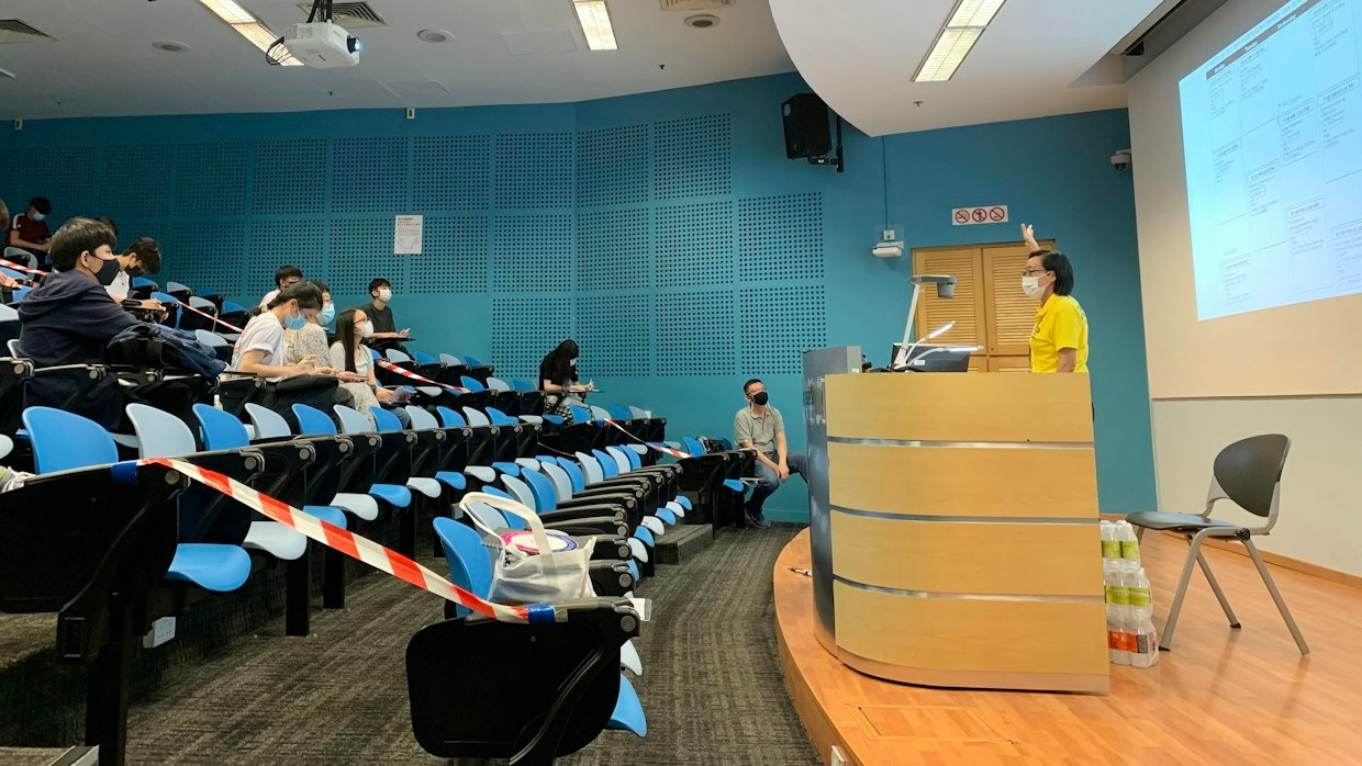 A lecture slide on a projector, the kind of visual content no caption-based summary can read.