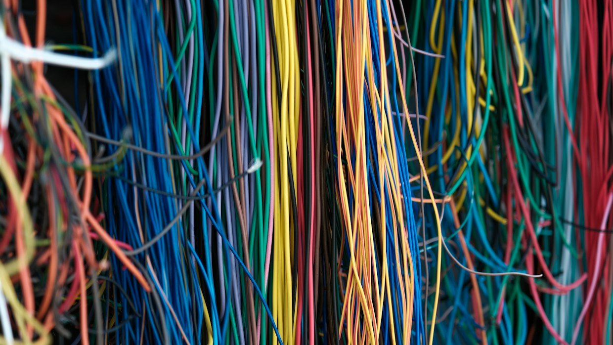Tangled wires spread on a surface.
