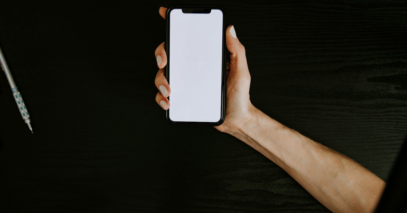A phone held up showing a video playing.