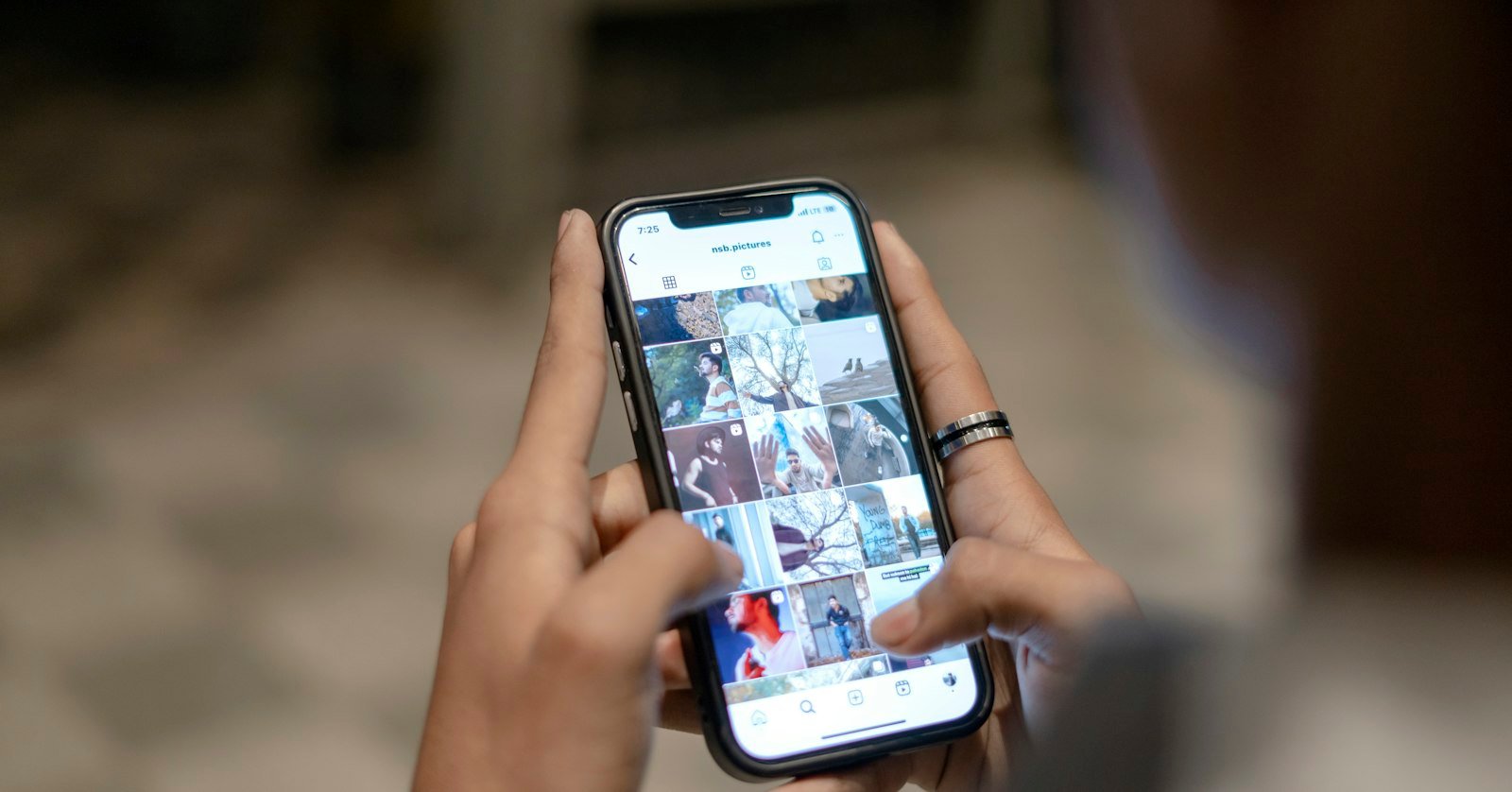 A hand holding a smartphone playing a video, for finding its transcript in the app.