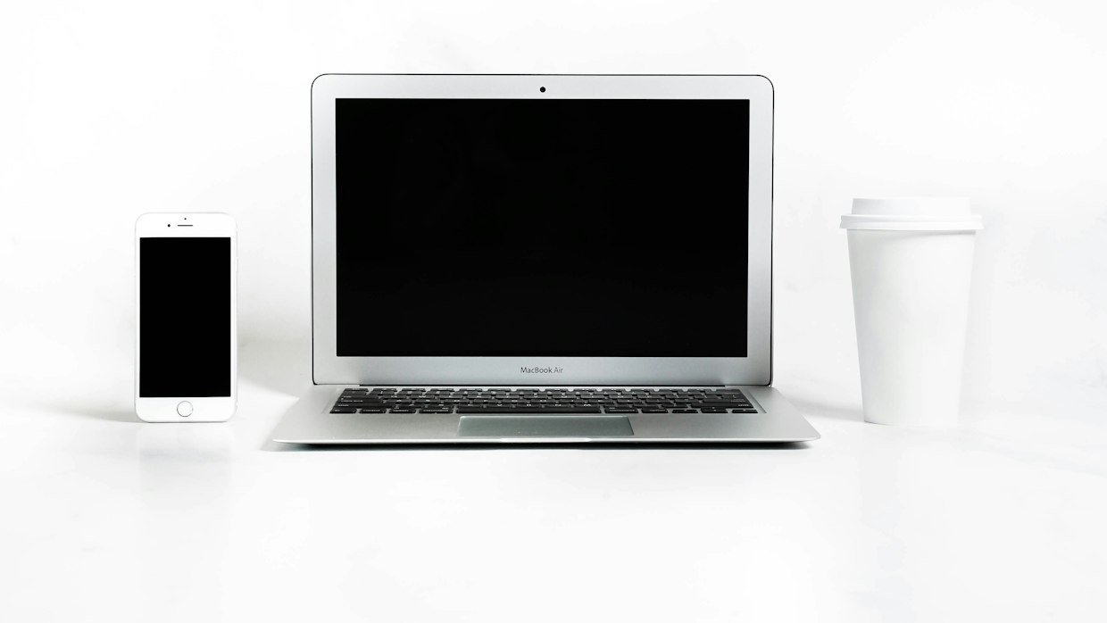 A laptop open next to a phone, the fallback when the app hides the transcript.