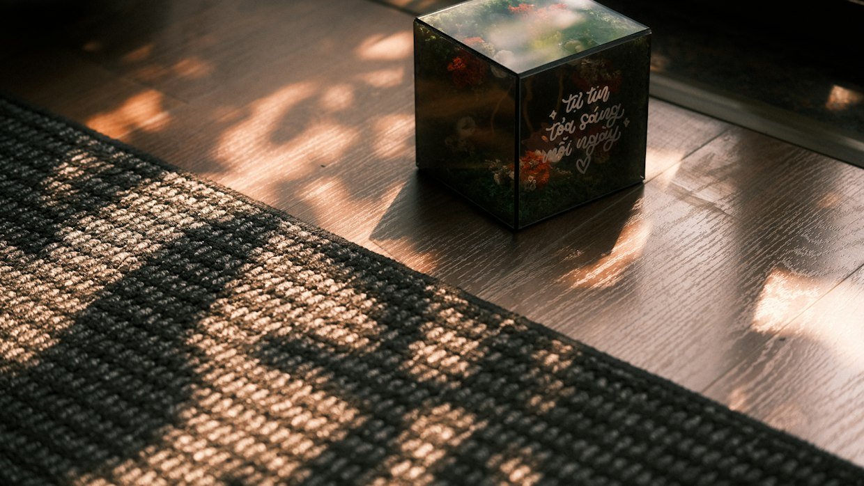 A sealed cardboard box on a floor.
