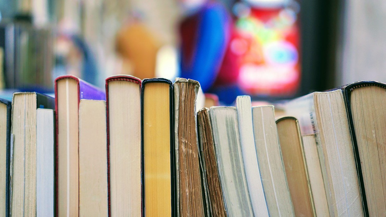 Several books stacked with markers between pages.