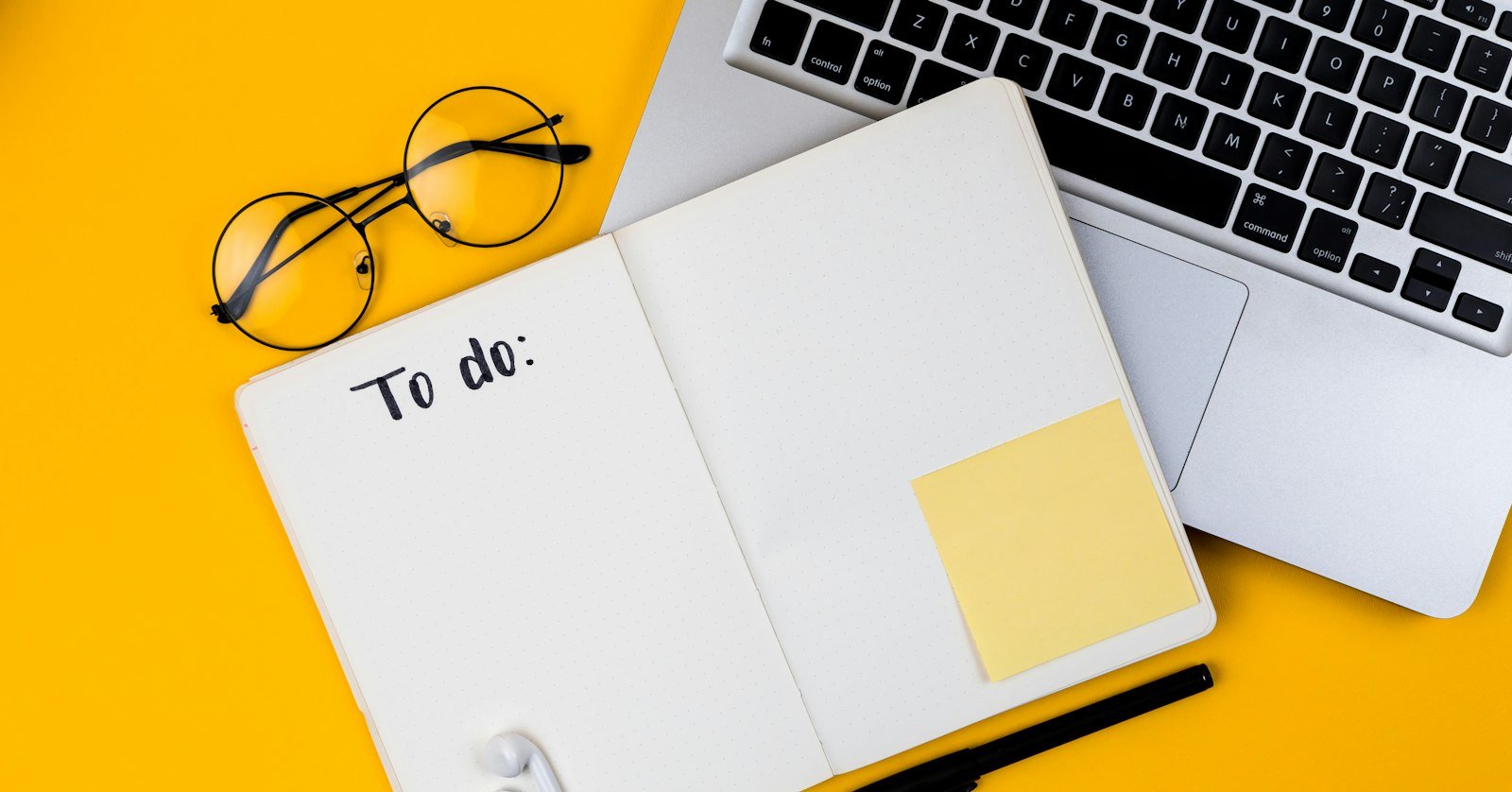 An open notebook next to a laptop.