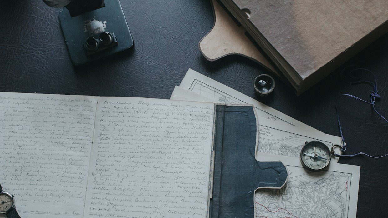 A stopwatch beside a notepad.