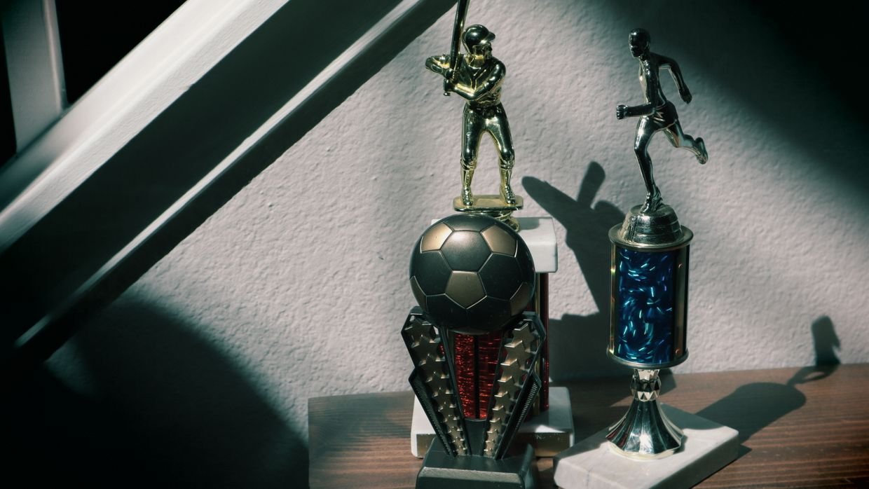 Two differently shaped trophies side by side.