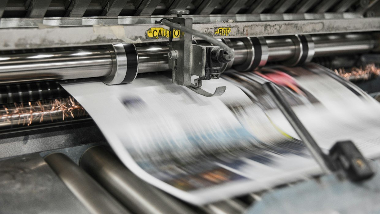 Printing press rollers in motion.