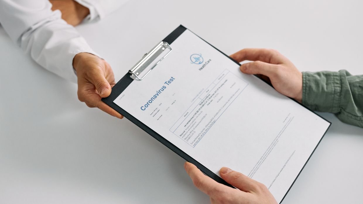 A hand checking details on a printed document.