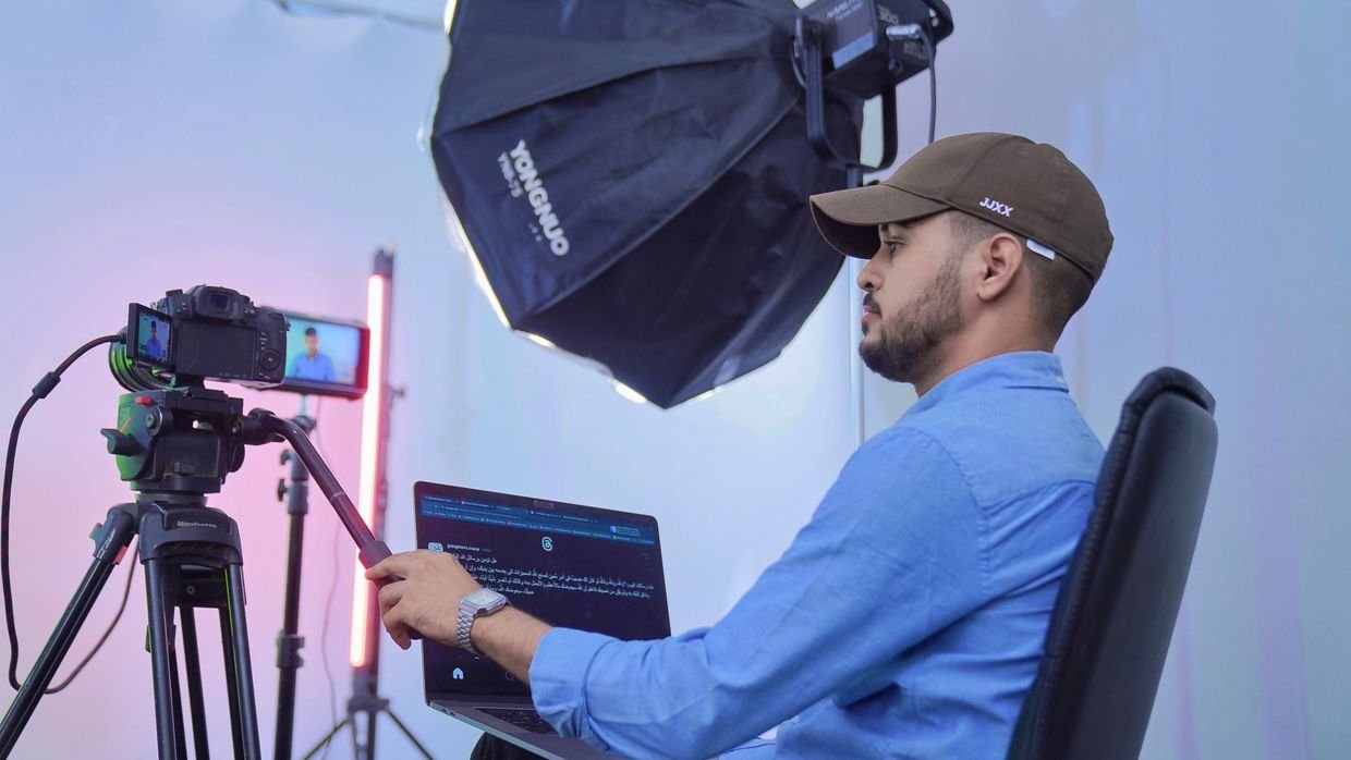 A creator recording a video, the person every newsletter item should name and link back to.