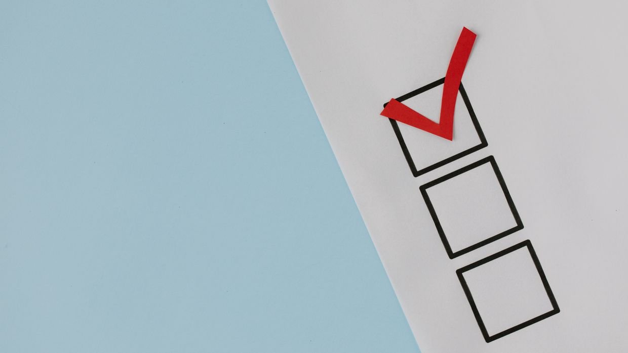 A checklist on a clipboard with ticks against it.