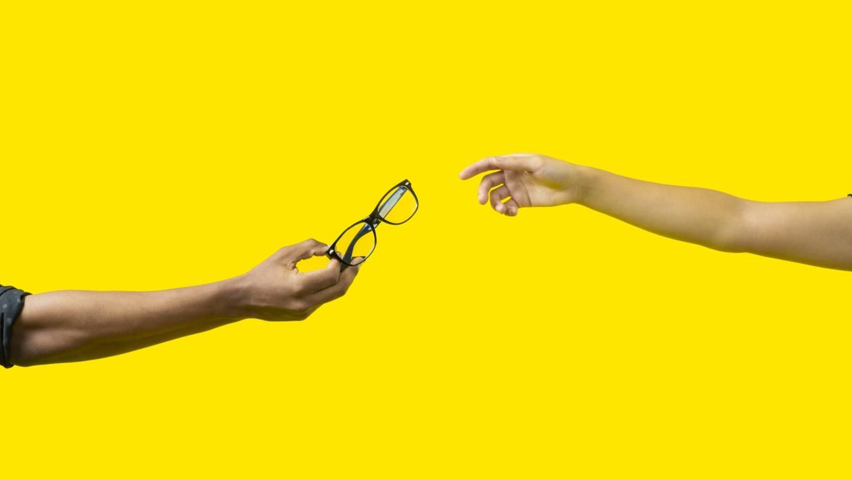 A hand reaching between two objects.