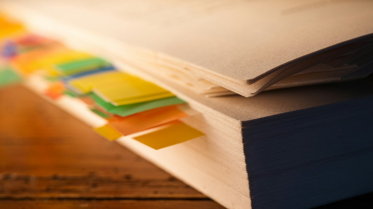 Coloured tabs marking pages in a book.