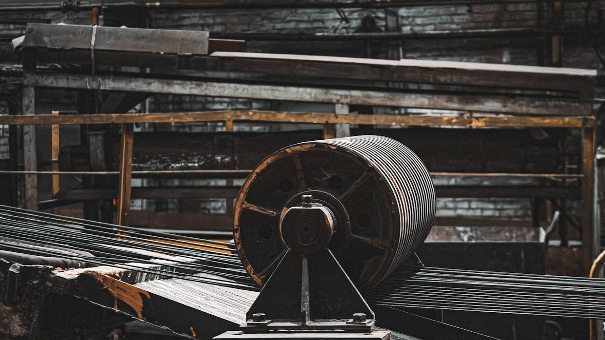 Metal conveyor rollers in a workshop.