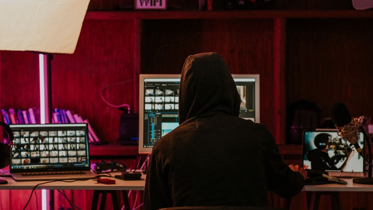 A creator editing a video at a computer, where caption tracks are managed.