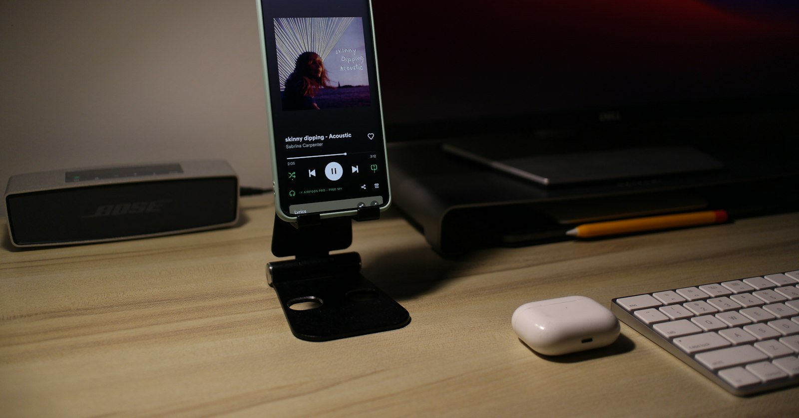 A phone playing a video on a desk, where the transcript option can be missing.