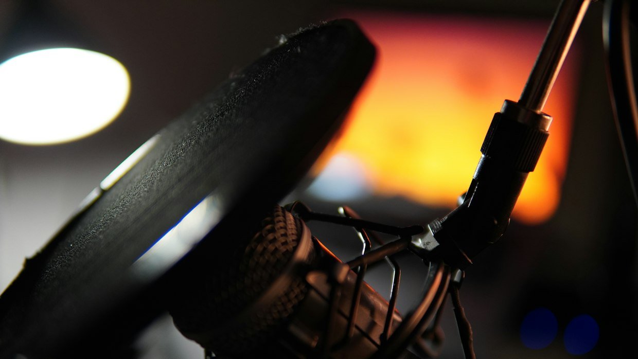 A microphone in a busy room, the kind of audio that produces weak automatic captions.